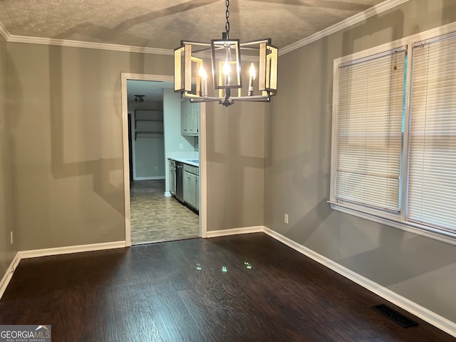 unfurnished dining area featuring crown molding, a textured ceiling, a chandelier, and hardwood / wood-style floors