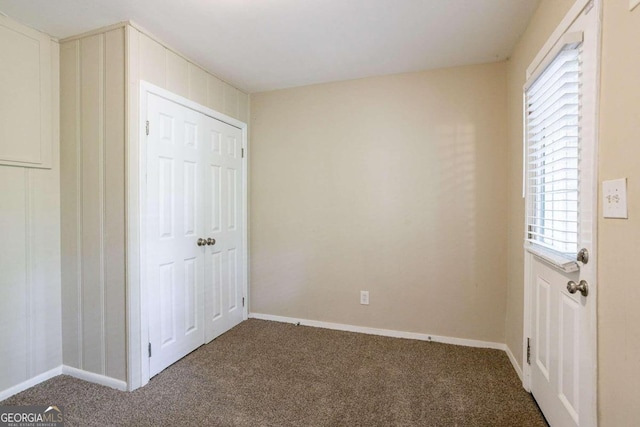 unfurnished bedroom featuring carpet flooring and a closet