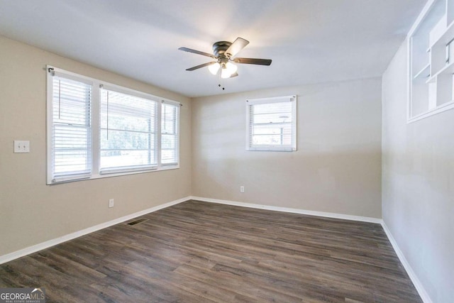 unfurnished room featuring ceiling fan and dark hardwood / wood-style flooring