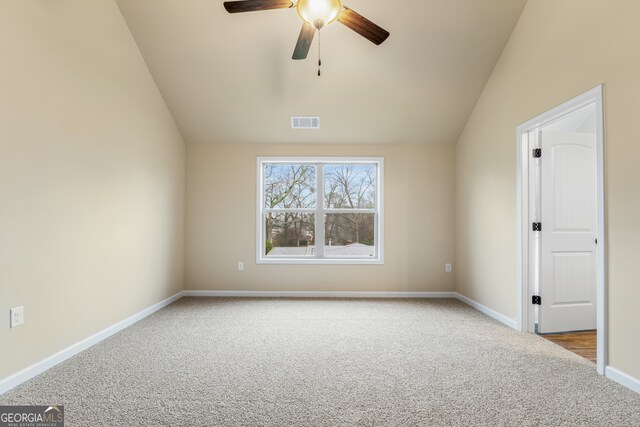 carpeted empty room with lofted ceiling and ceiling fan