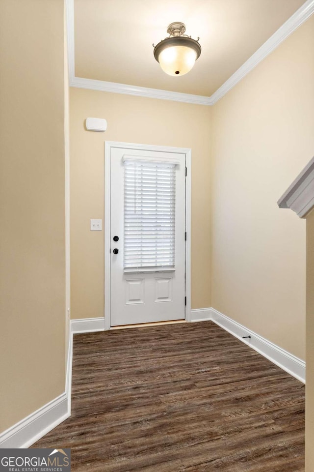 entrance foyer featuring ornamental molding and dark hardwood / wood-style flooring