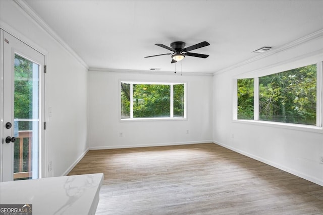 unfurnished room featuring ceiling fan, ornamental molding, and light hardwood / wood-style floors