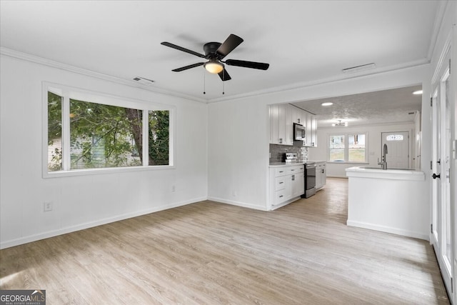 interior space featuring white cabinetry, light hardwood / wood-style flooring, stainless steel appliances, and ceiling fan