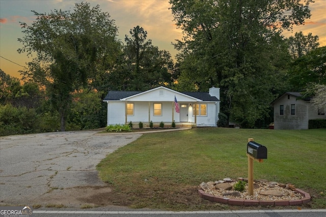 view of front of property with a lawn and a porch