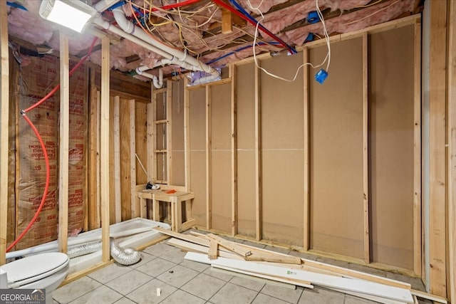 basement featuring tile patterned flooring