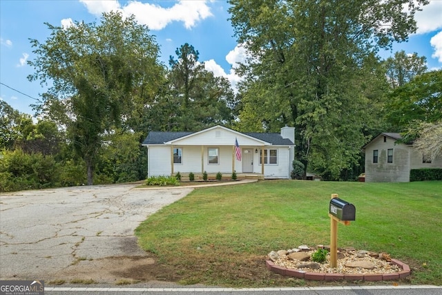 view of front facade with a front yard and a porch