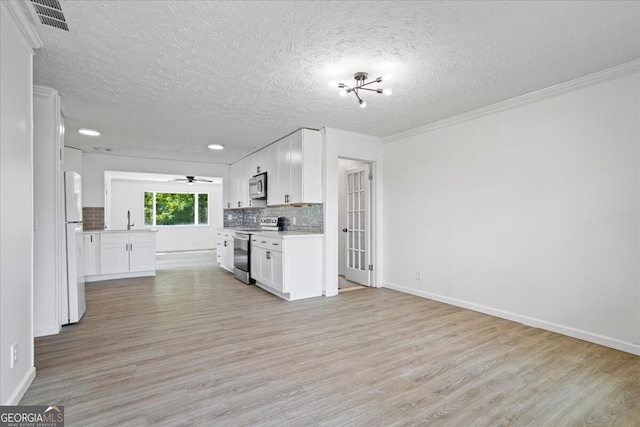 kitchen featuring ceiling fan, stainless steel appliances, light wood-type flooring, and white cabinets