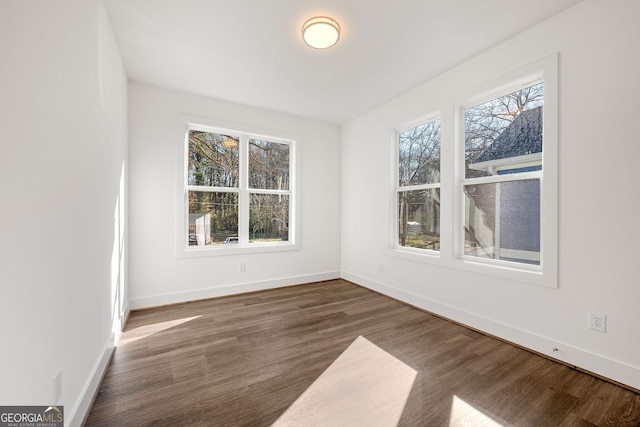 empty room featuring dark hardwood / wood-style flooring