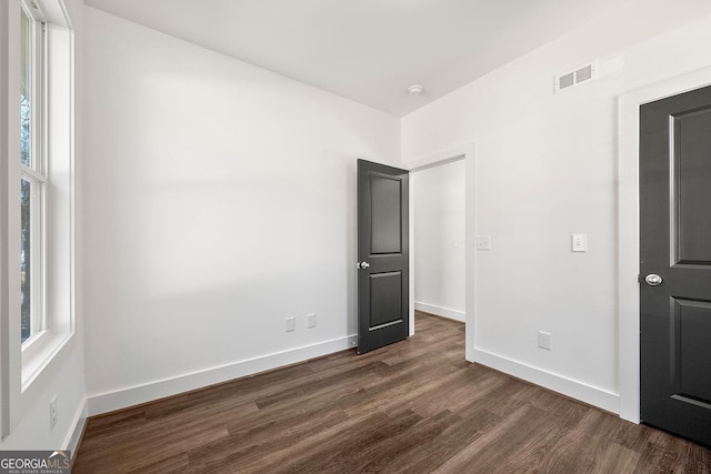 unfurnished bedroom featuring dark wood-type flooring