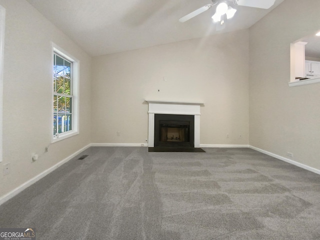 unfurnished living room with a fireplace with flush hearth, carpet, visible vents, and baseboards