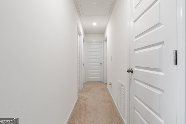 hall with light colored carpet