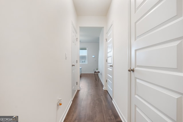 hallway with dark hardwood / wood-style flooring