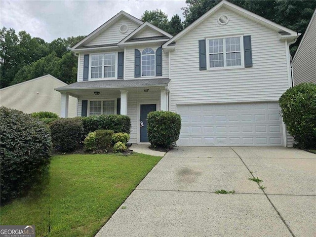 view of front property with a front yard and a garage