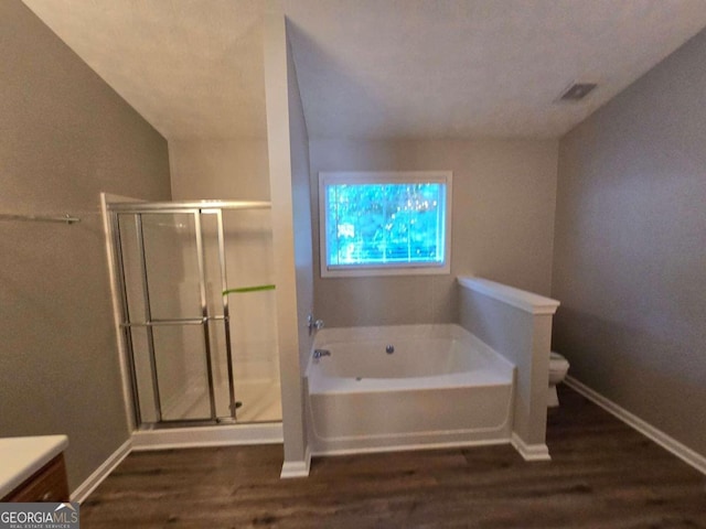 full bathroom with vanity, toilet, hardwood / wood-style flooring, and plus walk in shower