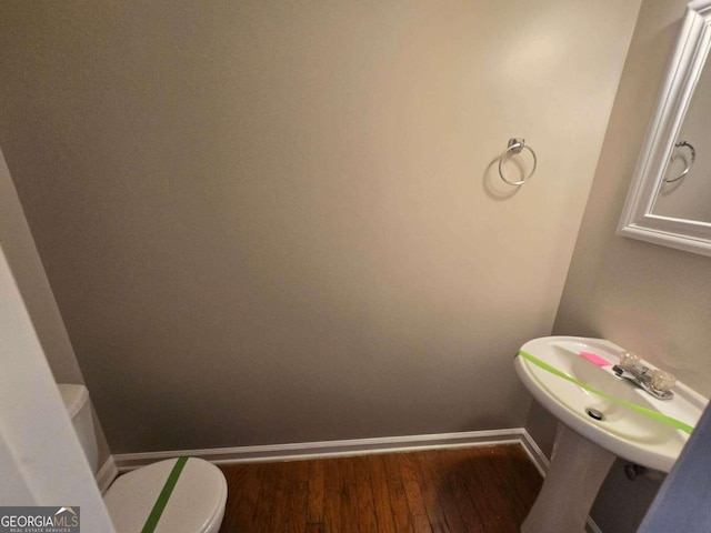 bathroom featuring hardwood / wood-style floors, toilet, and sink