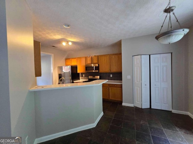 kitchen featuring a textured ceiling, backsplash, appliances with stainless steel finishes, kitchen peninsula, and sink