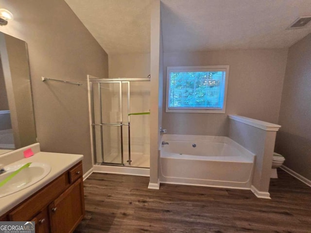 full bathroom with plus walk in shower, hardwood / wood-style floors, toilet, and vanity