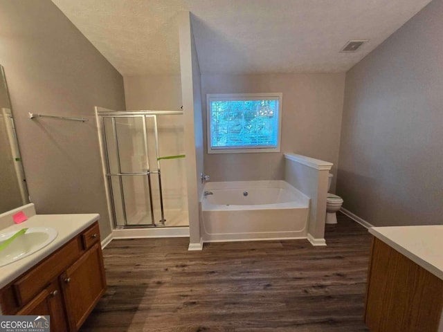 full bathroom with vanity, toilet, wood-type flooring, and independent shower and bath