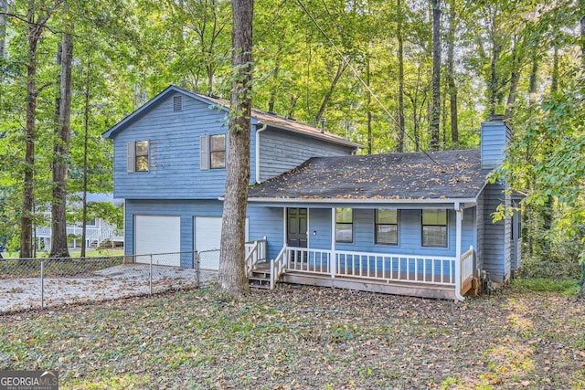 view of front facade featuring driveway, a porch, fence, a garage, and a chimney