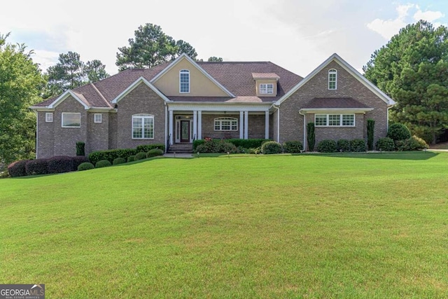 view of front of property with covered porch and a front yard