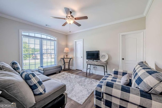 living room featuring ceiling fan, ornamental molding, and hardwood / wood-style floors