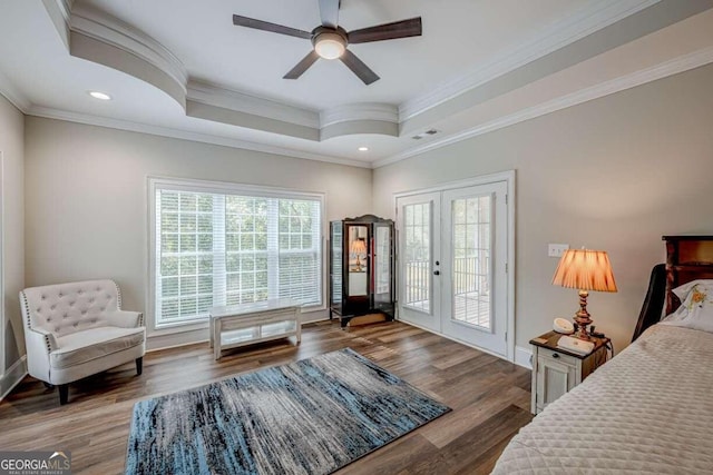 interior space with hardwood / wood-style floors, crown molding, access to outside, ceiling fan, and a tray ceiling