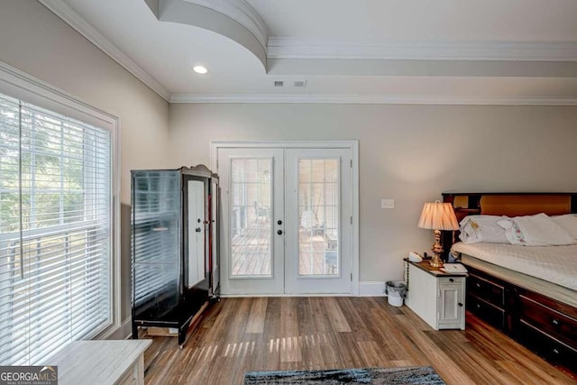 interior space with crown molding, light hardwood / wood-style flooring, and french doors