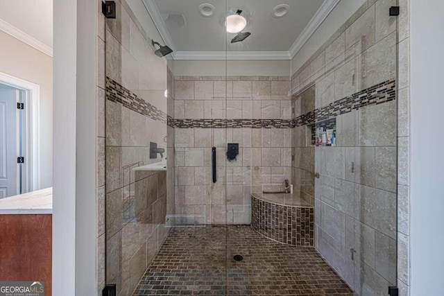 bathroom featuring crown molding and a shower with shower door