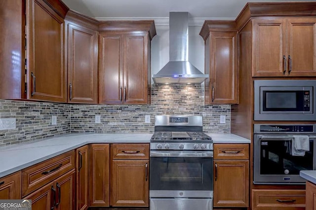 kitchen with wall chimney exhaust hood, appliances with stainless steel finishes, crown molding, and backsplash