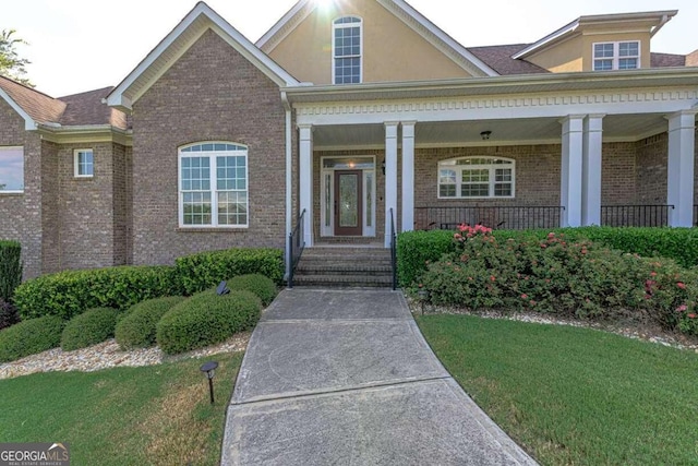 view of front facade with a front yard and a porch