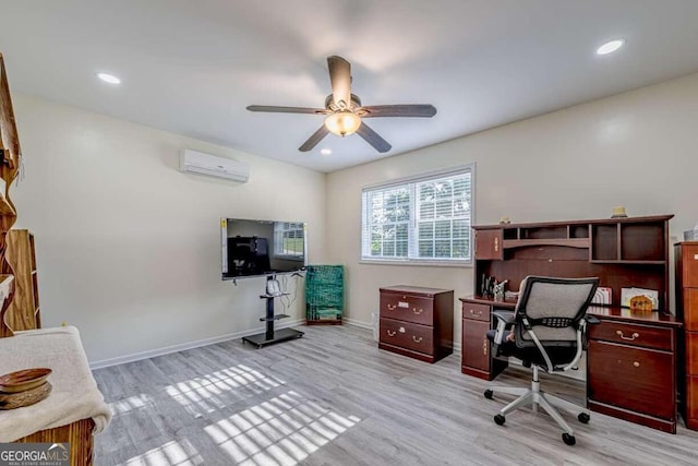 home office with a wall mounted AC, light wood-type flooring, and ceiling fan