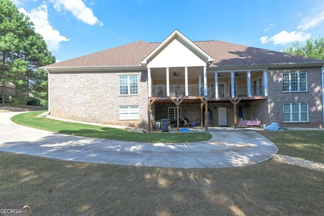 view of front of home with a balcony, a front yard, and a patio area