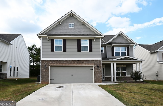 craftsman house featuring a garage and a front lawn