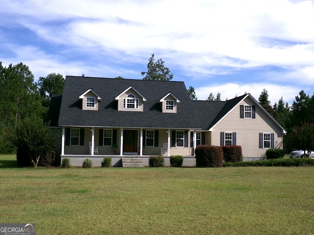 cape cod-style house with a front yard