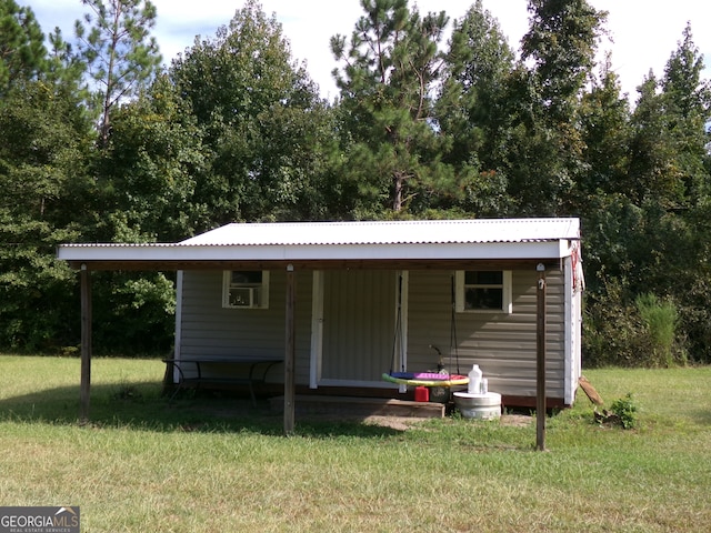 exterior space featuring a lawn and covered porch