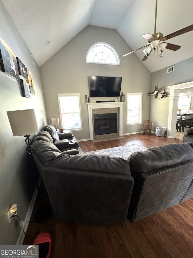 living room with a healthy amount of sunlight, ceiling fan, hardwood / wood-style flooring, and a fireplace