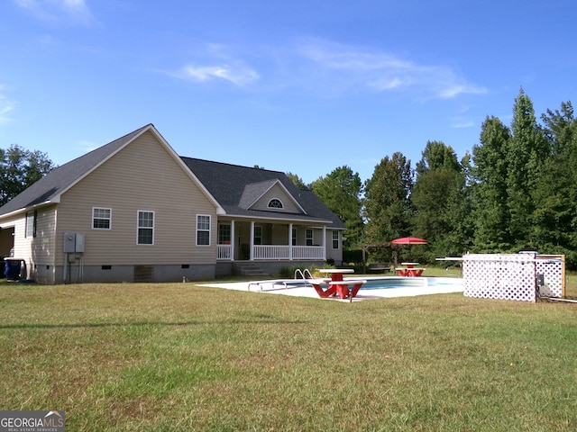 rear view of property featuring a lawn and a patio area