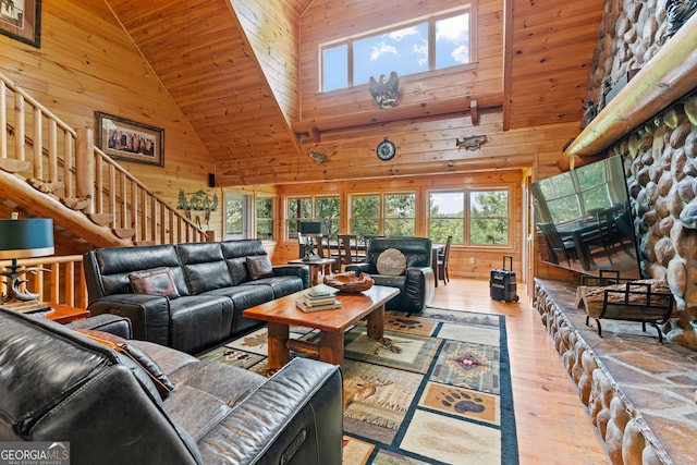 living room with light wood-type flooring, high vaulted ceiling, wooden walls, and wooden ceiling