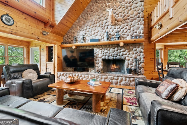 living room with high vaulted ceiling, wooden walls, wooden ceiling, and a fireplace