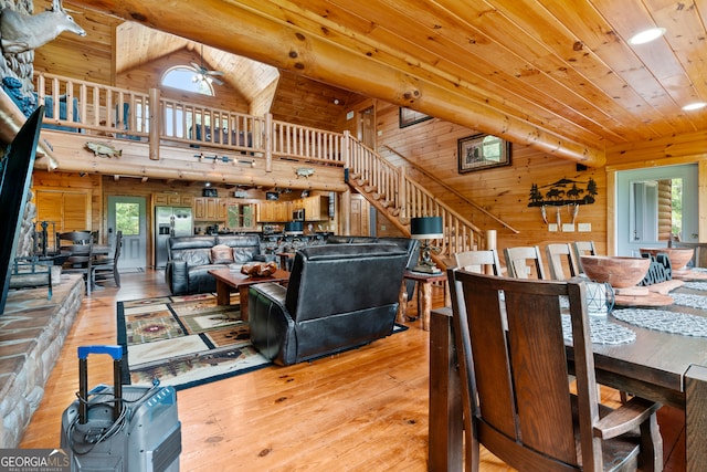 living room featuring hardwood / wood-style floors, a wealth of natural light, and wood walls