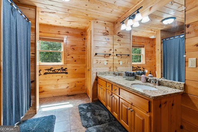 bathroom with tile patterned flooring, vanity, wood walls, and wooden ceiling