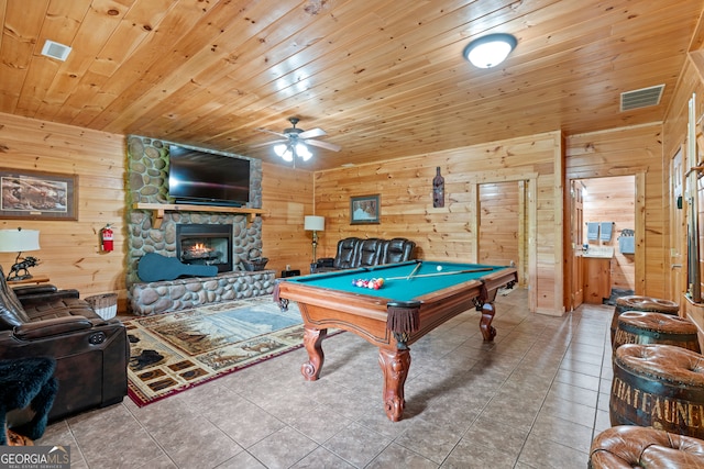 recreation room featuring billiards, wooden walls, ceiling fan, a stone fireplace, and wood ceiling