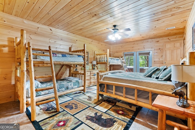 tiled bedroom featuring wood ceiling, wood walls, and ceiling fan