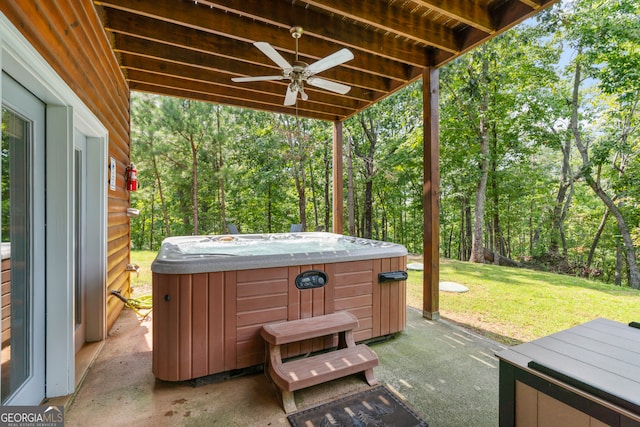 view of patio / terrace featuring ceiling fan and a hot tub