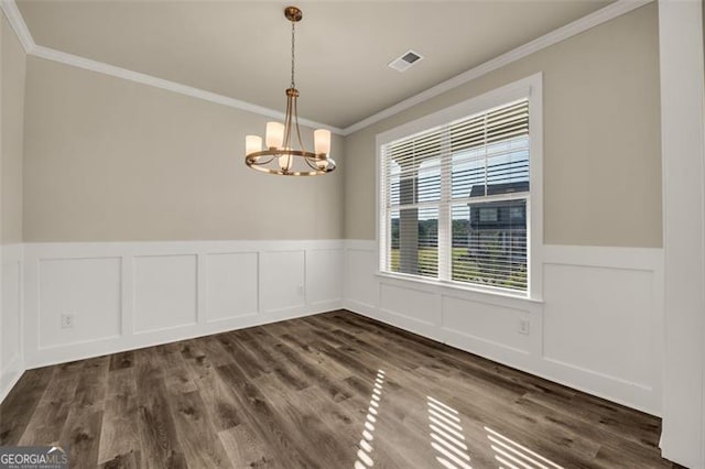 unfurnished dining area with ornamental molding, a chandelier, and dark hardwood / wood-style floors