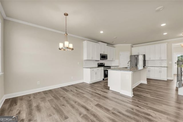 kitchen featuring an island with sink, hanging light fixtures, appliances with stainless steel finishes, white cabinets, and light hardwood / wood-style floors