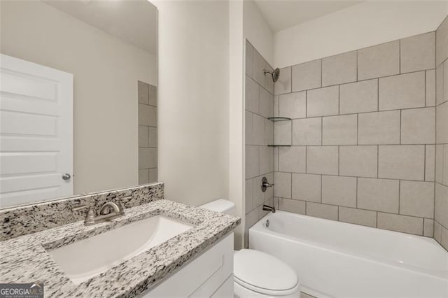 full bathroom with tiled shower / bath combo, vanity, and toilet