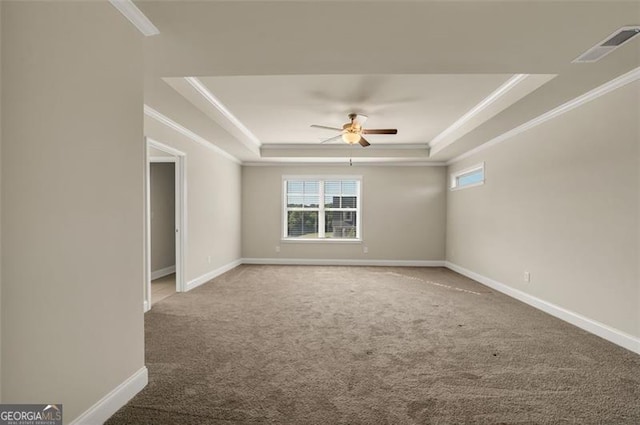 carpeted empty room featuring crown molding, ceiling fan, and a tray ceiling