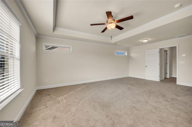 empty room featuring a healthy amount of sunlight, ceiling fan, and carpet