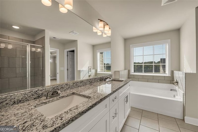 bathroom featuring tile patterned flooring, shower with separate bathtub, and vanity